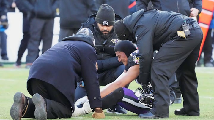 Dec 24, 2022; Baltimore, Maryland, USA; Baltimore Ravens medical staff attends to safety Kyle Hamilton (14) during the third quarter against the Atlanta Falcons at M&T Bank Stadium. Mandatory Credit: Mitch Stringer-Imagn Images