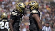 Purdue Boilermakers linebacker Alex Sanford Jr. and defensive lineman Demeco Kennedy celebrate 