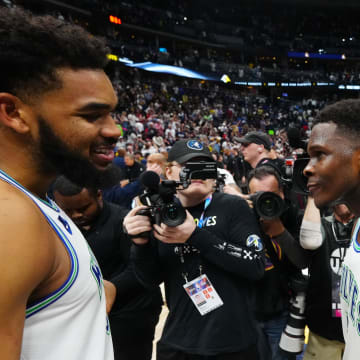 May 19, 2024; Denver, Colorado, USA; Minnesota Timberwolves center Karl-Anthony Towns (32) and Anthony Edwards (5) celebrate defeating the Denver Nuggets in game seven of the second round for the 2024 NBA playoffs at Ball Arena. Mandatory Credit: Ron Chenoy-USA TODAY Sports