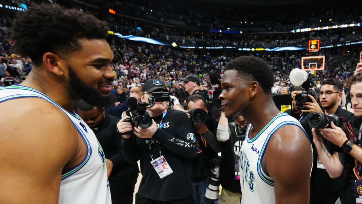 May 19, 2024; Denver, Colorado, USA; Minnesota Timberwolves center Karl-Anthony Towns (32) and Anthony Edwards (5) celebrate defeating the Denver Nuggets in game seven of the second round for the 2024 NBA playoffs at Ball Arena. Mandatory Credit: Ron Chenoy-USA TODAY Sports