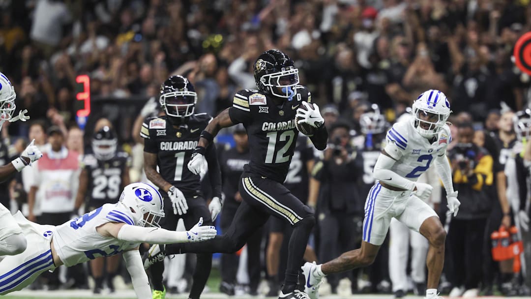 Dec 28, 2024; San Antonio, TX, USA; Colorado Buffaloes wide receiver Travis Hunter (12) runs with the ball during the second quarter against the Brigham Young Cougars at Alamodome. Mandatory Credit: Troy Taormina-Imagn Images