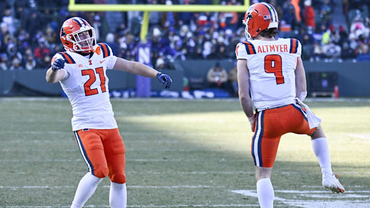Nov 30, 2024; Chicago, Illinois, USA; Illinois Fighting Illini running back Aidan Laughery (21) celebrates with quarterback Luke Altmyer (9) after scoring a touchdown against the Northwestern Wildcats during the second half at Wrigley Field. Mandatory Credit: Matt Marton-Imagn Images Nov 30, 2024; Chicago, Illinois, USA; Illinois Fighting Illini running back Aidan Laughery (21) celebrates with quarterback Luke Altmyer (9) after scoring a touchdown against the Northwestern Wildcats during the second half at Wrigley Field. Mandatory Credit: Matt Marton-Imagn Images
