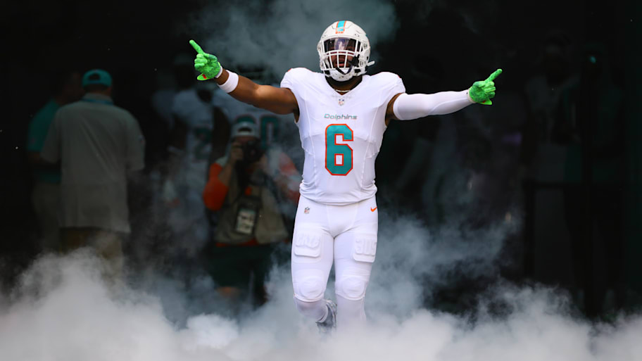 Anthony Walker Jr. runs out of the tunnel onto the field.