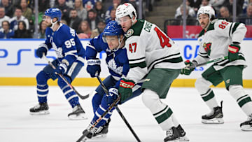 Jan 29, 2025; Toronto, Ontario, CAN;  Minnesota Wild defenseman Declan Chisholm (47) covers Toronto Maple Leafs forward Max Domi (11) in the first period at Scotiabank Arena. Mandatory Credit: Dan Hamilton-Imagn Images