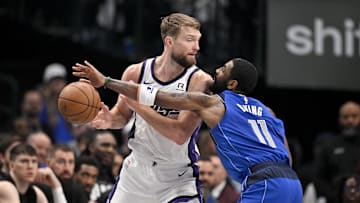 Feb 10, 2025; Dallas, Texas, USA; Dallas Mavericks guard Kyrie Irving (11) knocks the ball away from Sacramento Kings forward Domantas Sabonis (11) during the first quarter at the American Airlines Center. Mandatory Credit: Jerome Miron-Imagn Images
