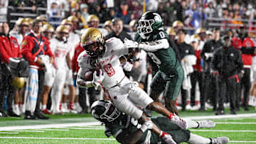 Sep 21, 2024; Chestnut Hill, Massachusetts, USA; Boston College Eagles running back Treshaun Ward (0) is tackled by Michigan State Spartans defensive back Charles Brantley (0) and linebacker Jordan Hall (5) during the first half at Alumni Stadium. Mandatory Credit: Eric Canha-Imagn Images