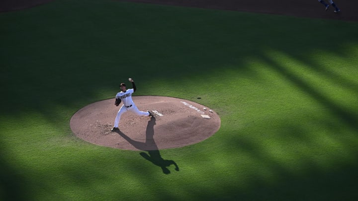 Aug 4, 2023; San Diego, California, USA; San Diego Padres starting pitcher Blake Snell (4) throws a pitch during the second inning as Los Angeles Dodgers third baseman Chris Taylor (top) steals third base at Petco Park. Mandatory Credit: Orlando Ramirez-USA TODAY Sports