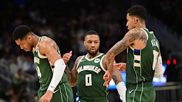 Feb 27, 2025; Milwaukee, Wisconsin, USA;  Milwaukee Bucks guard Damian Lillard (0) celebrates a three-point basket with forward Giannis Antetokounmpo (34) and forward Kyle Kuzma (18) in the fourth quarter against the Denver Nuggets at Fiserv Forum. Mandatory Credit: Benny Sieu-Imagn Images