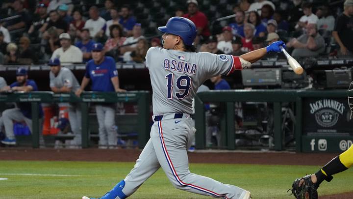 Sep 3, 2025; Phoenix, Arizona, USA; Texas Rangers outfielder Alejandro Osuna (19) hits a single against the Arizona Diamondbacks in the fifth inning at Chase Field. Mandatory Credit: Rick Scuteri-Imagn Images