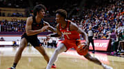 Jan 4, 2025; Blacksburg, Virginia, USA; Virginia Tech Hokies forward Tobi Lawal (1) drives to the basket against Miami Hurricanes forward Isaiah Johnson-Arigu (4) during the first half at Cassell Coliseum. Mandatory Credit: Peter Casey-Imagn Images