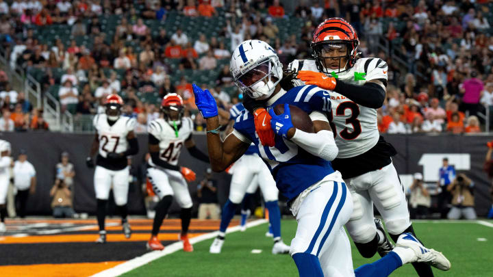 Indianapolis Colts wide receiver Adonai Mitchell (10) scores a touchdown as Cincinnati Bengals safety Daijahn Anthony (33) attempts to stop him in the first quarter at Paycor Stadium in Cincinnati on Thursday, Aug. 22, 2024.