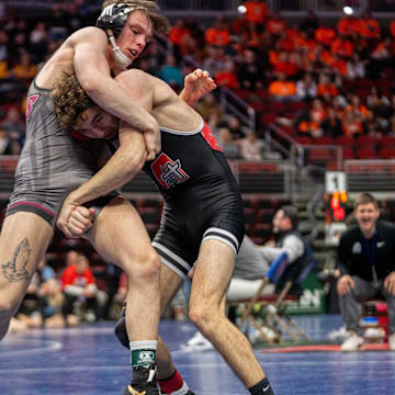 Assumption Davenport's Steele Diercks wrestles Oskaloosa's Kaiden Parker at 132 lbs during the Iowa high school boys state wrestling tournament on Thursday, Feb. 20, 2025, at Wells Fargo Arena in Des Moines.