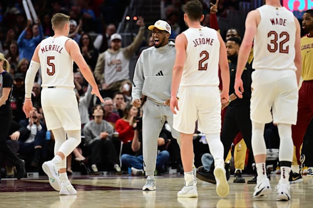 Donovan Mitchell, middle, celebrates with guard Sam Merrill (5) during the second half