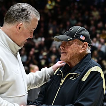 Purdue Boilermakers head coach Matt Painter shakes hands with former coach Gene Keady 