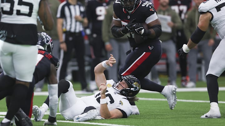 Nov 9, 2025; Houston, Texas, USA; Houston Texans defensive tackle Sheldon Rankins (90) intercepts a pass by Jacksonville Jaguars quarterback Trevor Lawrence (16) during the fourth quarter at NRG Stadium.