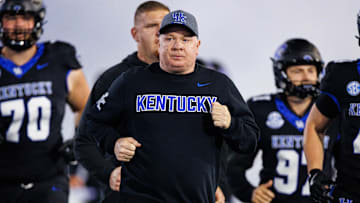 Oct 25, 2025; Lexington, Kentucky, USA; Kentucky Wildcats head coach Mark Stoops runs onto the field before the game against the Tennessee Volunteers at Kroger Field. Mandatory Credit: Jordan Prather-Imagn Images