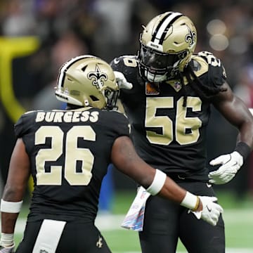Oct 5, 2025; New Orleans, Louisiana, USA; New Orleans Saints safety Terrell Burgess (26) and New Orleans Saints outside linebacker Demario Davis (56) celebrate a pass break up against the New York Giants during the second quarter at Caesars Superdome. Mandatory Credit: Matthew Hinton-Imagn Images