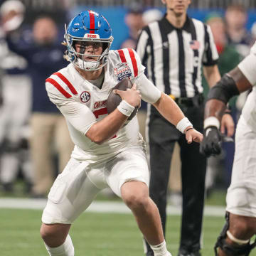 Dec 30, 2023; Atlanta, GA, USA; Mississippi Rebels quarterback Jaxson Dart (2) runs with the ball against the Penn State Nittany Lions during the first half at Mercedes-Benz Stadium. Mandatory Credit: Dale Zanine-USA TODAY Sports