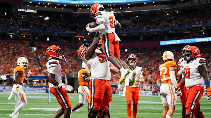 Syracuse offensive lineman Da'Metrius Weatherspoon (57) lifts Syracuse wide receiver Johntay Cook (2) in celebration after a touchdown during the Aflac Kickoff Game between the Volunteers and Syracuse held at Mercedes-Benz Stadium in Atlanta, Ga., on August 30, 2025. Syracuse offensive lineman Da'Metrius Weatherspoon (57) lifts Syracuse wide receiver Johntay Cook (2) in celebration after a touchdown during the Aflac Kickoff Game between the Volunteers and Syracuse held at Mercedes-Benz Stadium in Atlanta, Ga., on August 30, 2025.