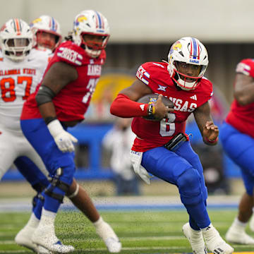 Nov 1, 2025; Lawrence, Kansas, USA; Kansas Jayhawks quarterback Jalon Daniels (6) runs the ball during the first half against the Oklahoma State Cowboys at David Booth Kansas Memorial Stadium. Mandatory Credit: Jay Biggerstaff-Imagn Images