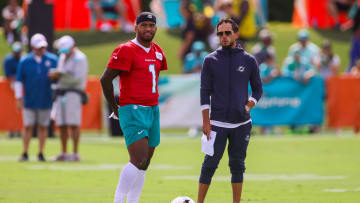 Jul 28, 2024; Miami Gardens, FL, USA; Miami Dolphins quarterback Tua Tagovailoa (1) talks to head coach Mike McDaniel during training camp at Baptist Health Training Complex. Mandatory Credit: Sam Navarro-USA TODAY Sports