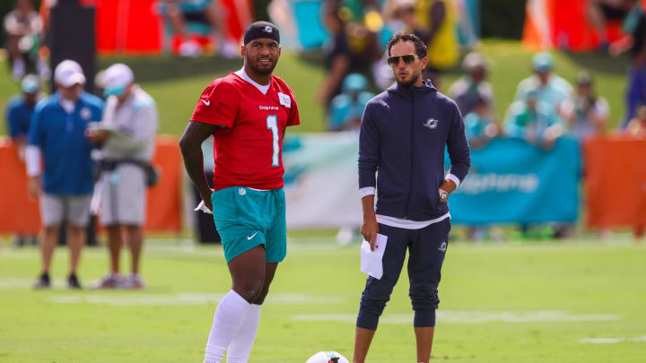 Jul 28, 2024; Miami Gardens, FL, USA; Miami Dolphins quarterback Tua Tagovailoa (1) talks to head coach Mike McDaniel during training camp at Baptist Health Training Complex. Mandatory Credit: Sam Navarro-USA TODAY Sports