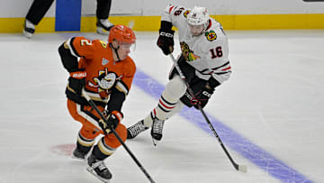 Nov 3, 2024; Anaheim, California, USA;  Anaheim Ducks defenseman Jackson LaCombe (2) and Chicago Blackhawks center Jason Dickinson (16) go for the puck in the first period at Honda Center. Mandatory Credit: Jayne Kamin-Oncea-Imagn Images