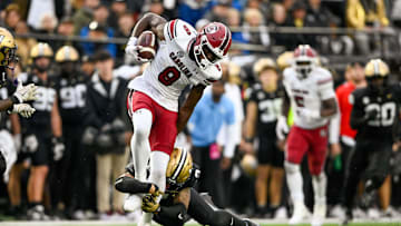 Nov 9, 2024; Nashville, Tennessee, USA;  South Carolina Gamecocks wide receiver Nyck Harbor (8) breaks the tackle of Vanderbilt Commodores linebacker Randon Fontenette (2) during the first half at FirstBank Stadium. Mandatory Credit: Steve Roberts-Imagn Images