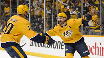 Mar 6, 2025; Nashville, Tennessee, USA;  Nashville Predators left wing Filip Forsberg (9) celebrates his goal with center Colton Sissons (10) against the Seattle Kraken during the first period at Bridgestone Arena. Mandatory Credit: Steve Roberts-Imagn Images