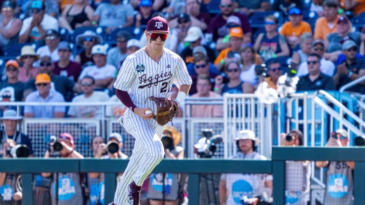 Jun 23, 2024; Omaha, NE, USA; Texas A&M Aggies first baseman Ted Burton (27) records an out against the Tennessee Volunteers during the ninth inning at Charles Schwab Field Omaha. Mandatory Credit: Dylan Widger-USA TODAY Sports