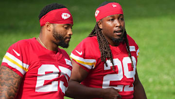 Jul 22, 2025; St. Joseph, MO, USA; Kansas City Chiefs running backs Elijah Mitchell (25) and Kareem Hunt (29) walk down the hill to the practice fields during training camp at Missouri Western State University. Mandatory Credit: Denny Medley-Imagn Images