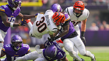 Sep 21, 2025; Minneapolis, Minnesota, USA; Cincinnati Bengals running back Chase Brown (30) is tackled during the first half against the Minnesota Vikings at U.S. Bank Stadium. Mandatory Credit: Brad Rempel-Imagn Images