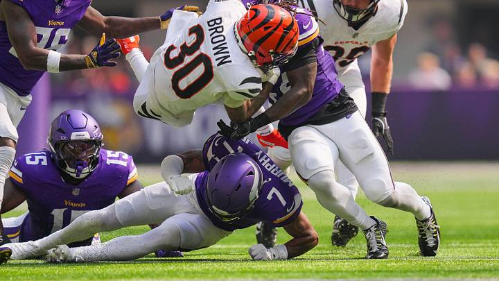 Sep 21, 2025; Minneapolis, Minnesota, USA; Cincinnati Bengals running back Chase Brown (30) is tackled during the first half against the Minnesota Vikings at U.S. Bank Stadium. Mandatory Credit: Brad Rempel-Imagn Images