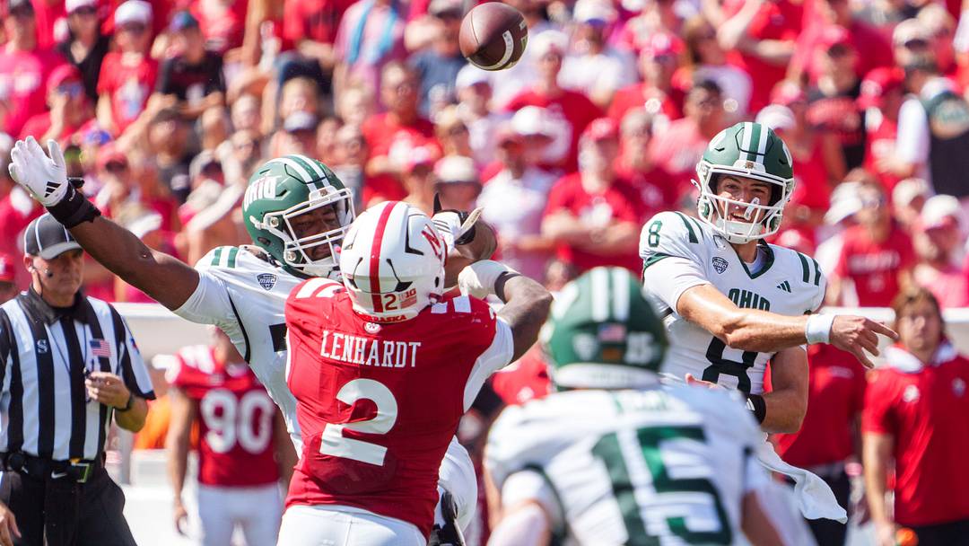 Ohio quarterback Nick Poulos fires a pass as the Huskers' Cam Lenhardt applies pressure. Ohio quarterback Nick Poulos fires a pass as the Huskers' Cam Lenhardt applies pressure.