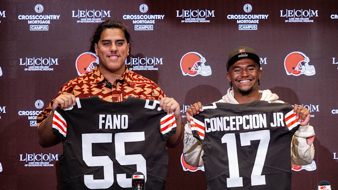 Apr 24, 2026; Berea, OH, USA; Cleveland Browns first round draft picks Spencer Fano, left, and KC Concepcion hold their new jerseys during an introductory press conference at CrossCountry Mortgage Campus. Mandatory Credit: Ken Blaze-Imagn Images