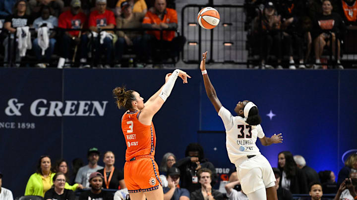 Sep 10, 2025; Uncasville, Connecticut, USA; Connecticut Sun guard Marina Mabrey (3) shoots over Atlanta Dream guard Maya Caldwell (33) during the first half at Mohegan Sun Arena. 