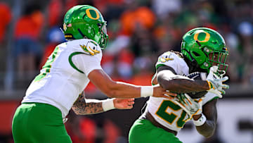 Oregon Ducks quarterback Dillon Gabriel (8) hands off the ball to Oregon Ducks running back Jordan James (20) during the annual rivalry game against the Oregon State Beavers on Saturday, Sept. 14, 2024 at Reser Stadium in Corvallis, Ore.