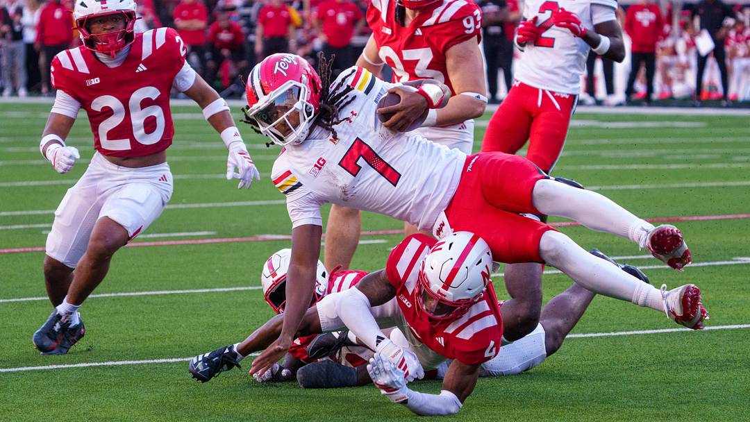 Maryland quarterback Malik Washington is tackled by Nebraska defensive back Jamir Conn (4) and linebacker Vincent Shavers Jr. during the third quarter. Maryland quarterback Malik Washington is tackled by Nebraska defensive back Jamir Conn (4) and linebacker Vincent Shavers Jr. during the third quarter.
