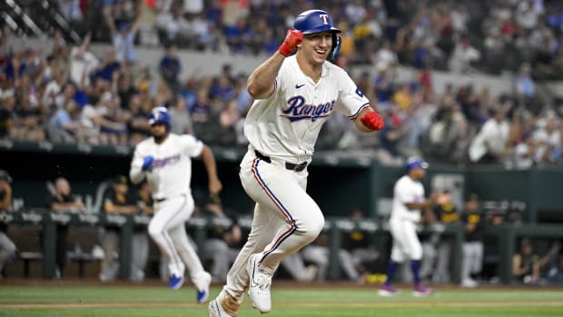 Wyatt Langford celebrates his walk-off single in the ninth, which scored Ezequiel Duran (background) with the winning run.