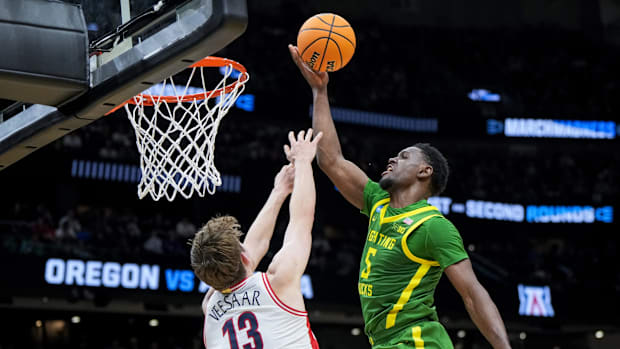 Mar 23, 2025; Seattle, WA, USA;  Arizona Wildcats forward Henri Veesaar (13) fouls as Oregon Ducks guard TJ Bamba (5) drives 