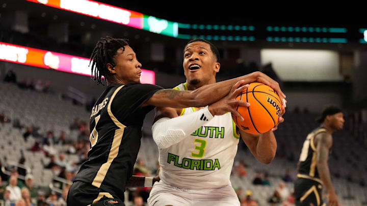 Mar 16, 2024; Fort Worth, TX, USA;  South Florida Bulls guard Chris Youngblood (3) drives to the basket and is fouled by UAB Blazers guard Eric Gaines (4) during the first half at Dickies Arena. Mandatory Credit: Chris Jones-Imagn Images