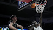 Nov 26, 2025; Cincinnati, Ohio, USA;  Cincinnati Bearcats center Moustapha Thiam (52) misses a dunk against Eastern Michigan Eagles forward Mohammad Habhab (4) in the second half at Fifth Third Arena. Mandatory Credit: Aaron Doster-Imagn Images