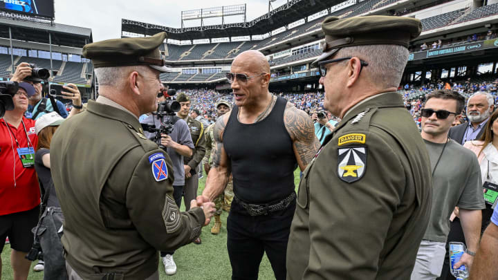 Mar 30, 2024; Arlington, TX, USA; UFL owner Dwayne Johnson talks with members of the US Army before the game between the Arlington Renegades and the Birmingham Stallions at Choctaw Stadium. Mandatory Credit: Jerome Miron-USA TODAY Sports