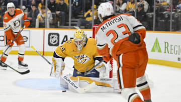 Mar 20, 2025; Nashville, Tennessee, USA;  Nashville Predators goaltender Justus Annunen (29) blocks the shot of Anaheim Ducks center Mason McTavish (23) during the second period at Bridgestone Arena. Mandatory Credit: Steve Roberts-Imagn Images