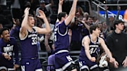 Mar 12, 2025; Indianapolis, IN, USA; Northwestern Wildcats forward Luke Hunger (33), Northwestern Wildcats center Keenan Fitzmorris (5) and Northwestern Wildcats guard Angelo Ciaravino (44) celebrate from the bench after a play during the second half against the Minnesota Golden Gophers at Gainbridge Fieldhouse. Mandatory Credit: Robert Goddin-Imagn Images