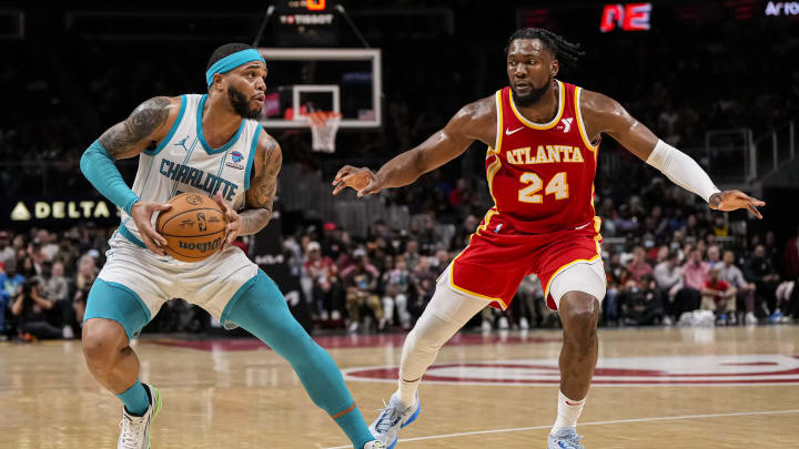 Apr 10, 2024; Atlanta, Georgia, USA; Charlotte Hornets forward Miles Bridges (0) steps back to shoot against Atlanta Hawks forward Bruno Fernando (24) during the second half at State Farm Arena. Mandatory Credit: Dale Zanine-USA TODAY Sports