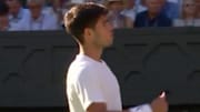 A concerned Alcaraz looks to the crowd to check on a fan who had fallen ill during his first-round match at Wimbledon. 