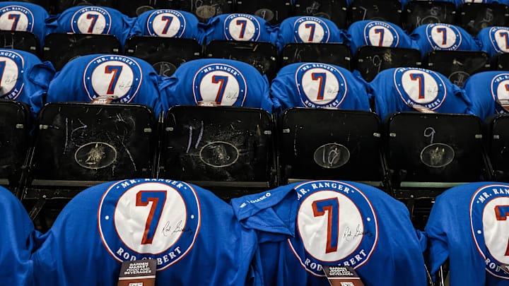 Oct 14, 2021; New York, New York, USA; T-shirts honor late New York Rangers Rod Gilbert are placed on seats before the game between the Rangers and the Dallas Stars at Madison Square Garden. Mandatory Credit: Vincent Carchietta-Imagn Images