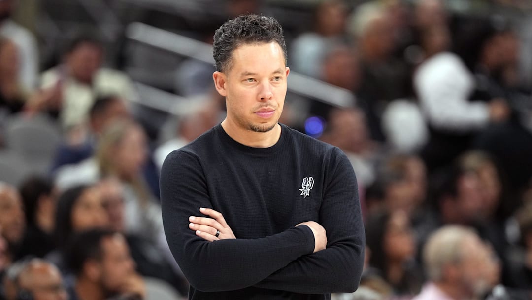 Apr 6, 2026; San Antonio, Texas, USA; San Antonio Spurs head coach Mitch Johnson observes the first half of play against the Philadelphia 76ers at Frost Bank Center. Mandatory Credit: Scott Wachter-Imagn Images