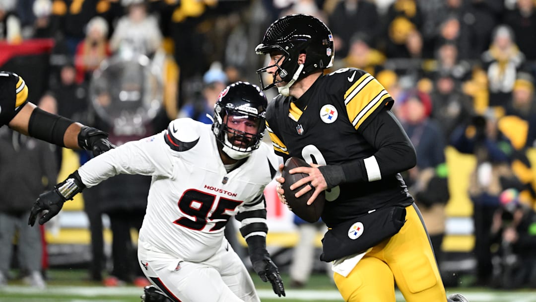 Jan 12, 2026; Pittsburgh, PA, USA; Pittsburgh Steelers quarterback Aaron Rodgers (8) scrambles from Houston Texans defensive end Derek Barnett (95) during the first half of an AFC Wild Card Round game at Acrisure Stadium. Mandatory Credit: Barry Reeger-Imagn Images